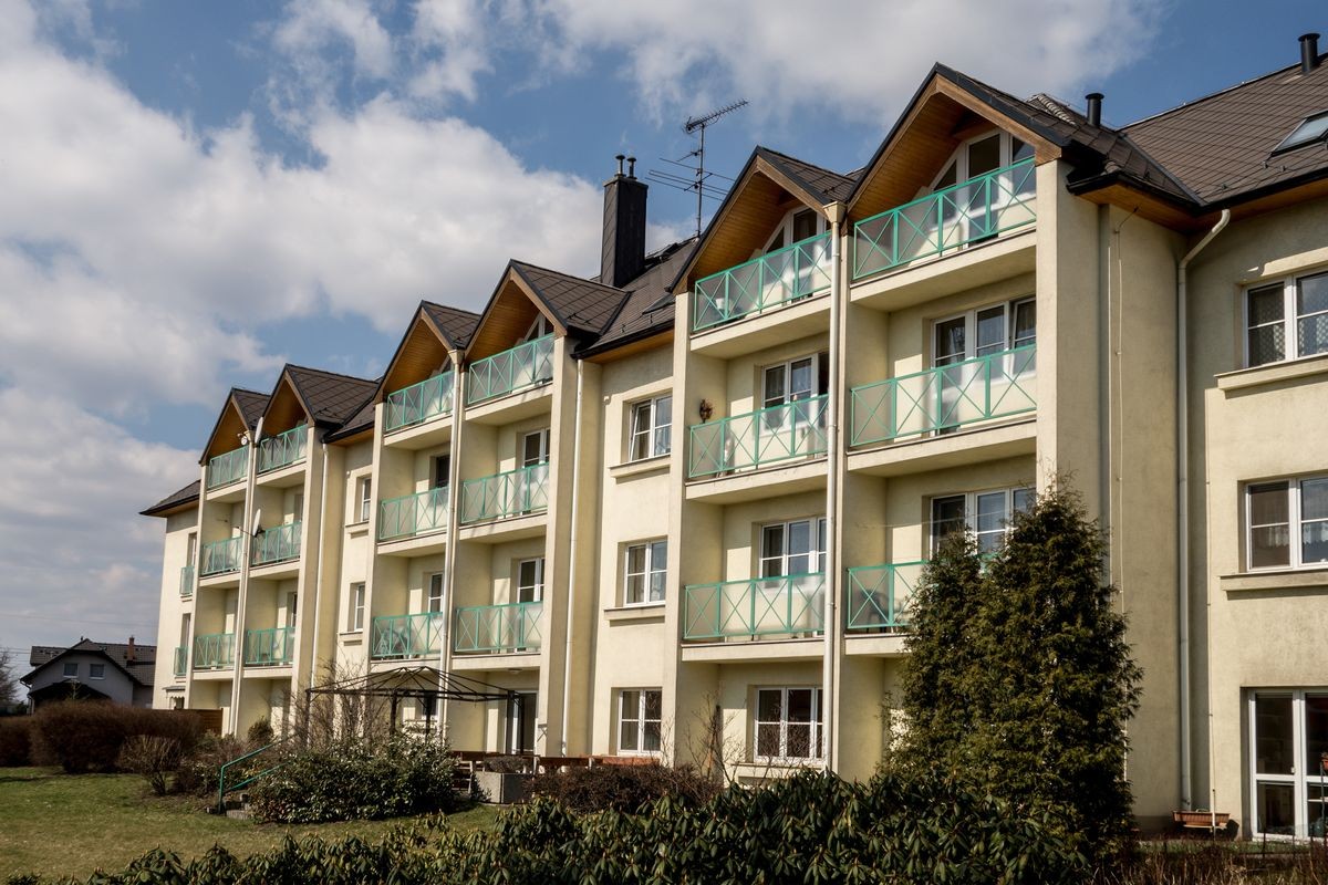 Block of yellow modern apartments in suburban area